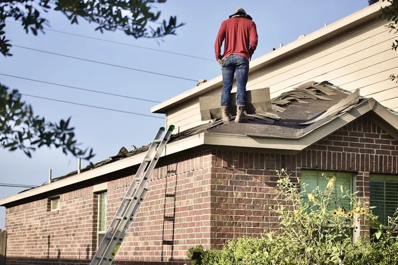 Professional roofer working on a residential roof in East Natick